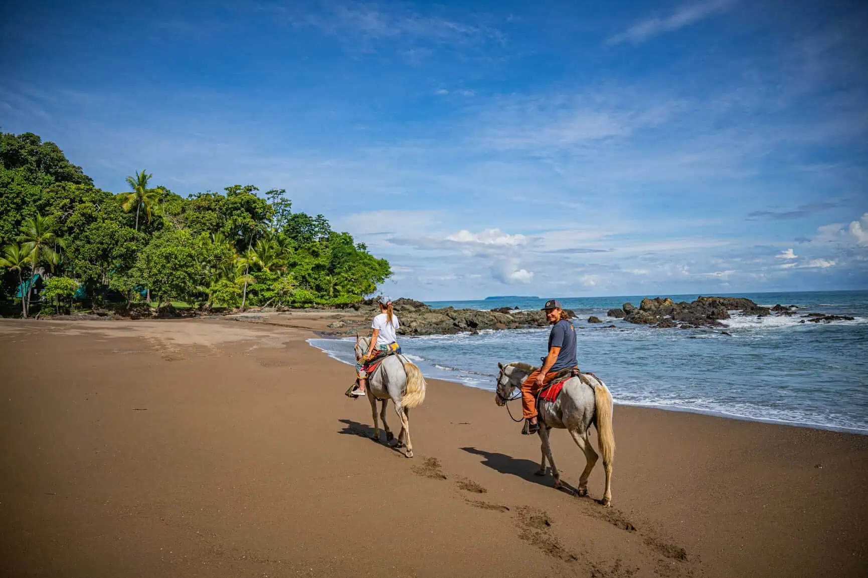 Horseback riding along the beach at low tide near Playa Flamingo, Costa Rica