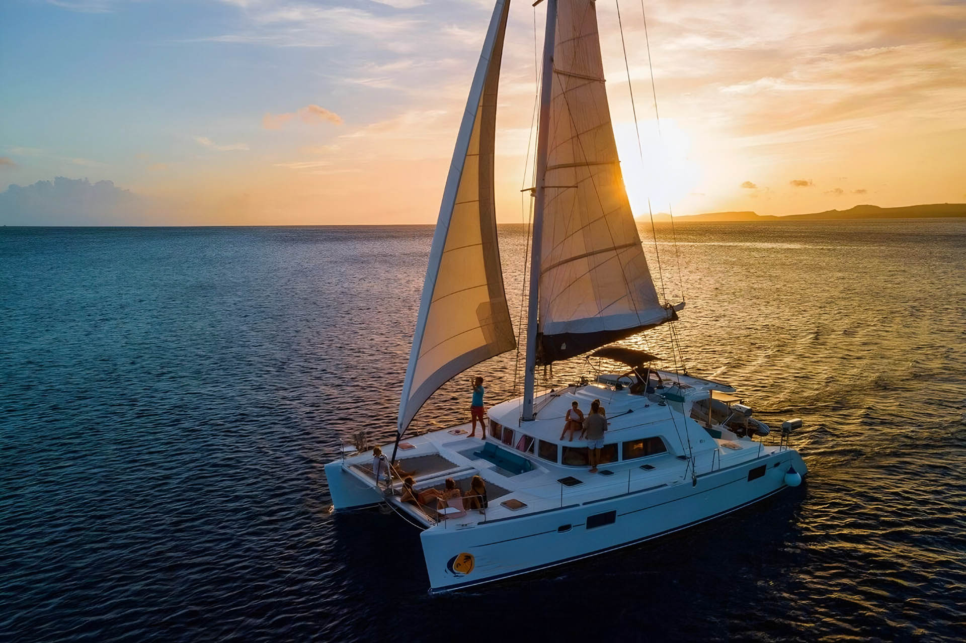 Sunset catamaran sail off Playa Flamingo with the Catalina Islands on the horizon